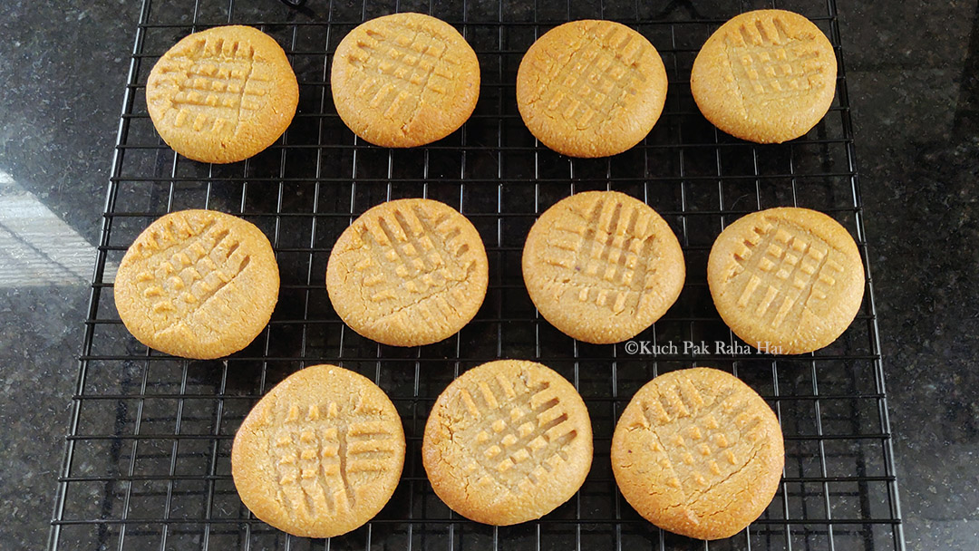 Almond flour peanut cookies cooling on wire rack.