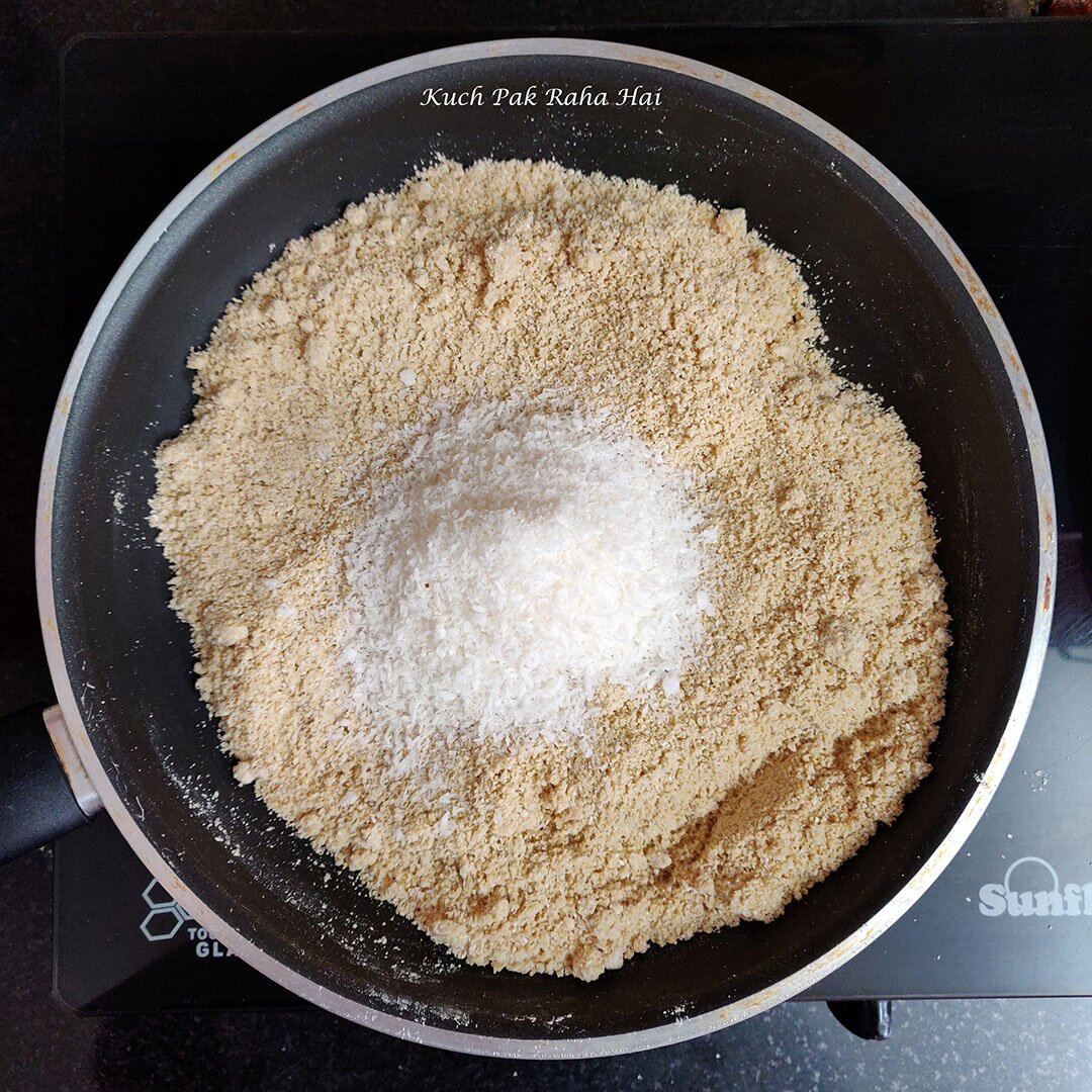 Adding coconut to roasted oats.