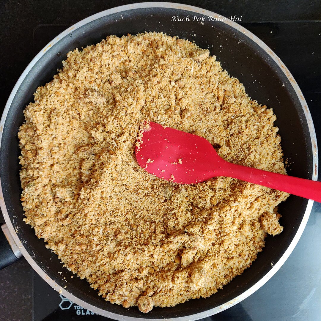 Adding jaggery to oats modak mixture.