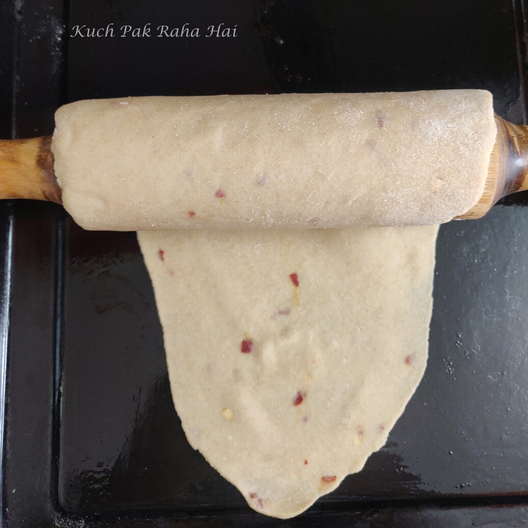 Transferring the rolled dough on baking sheet.