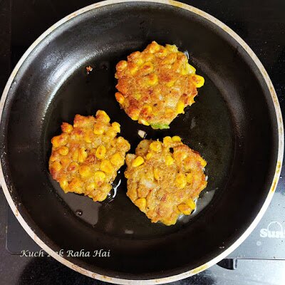 Making corn fritters in pan.