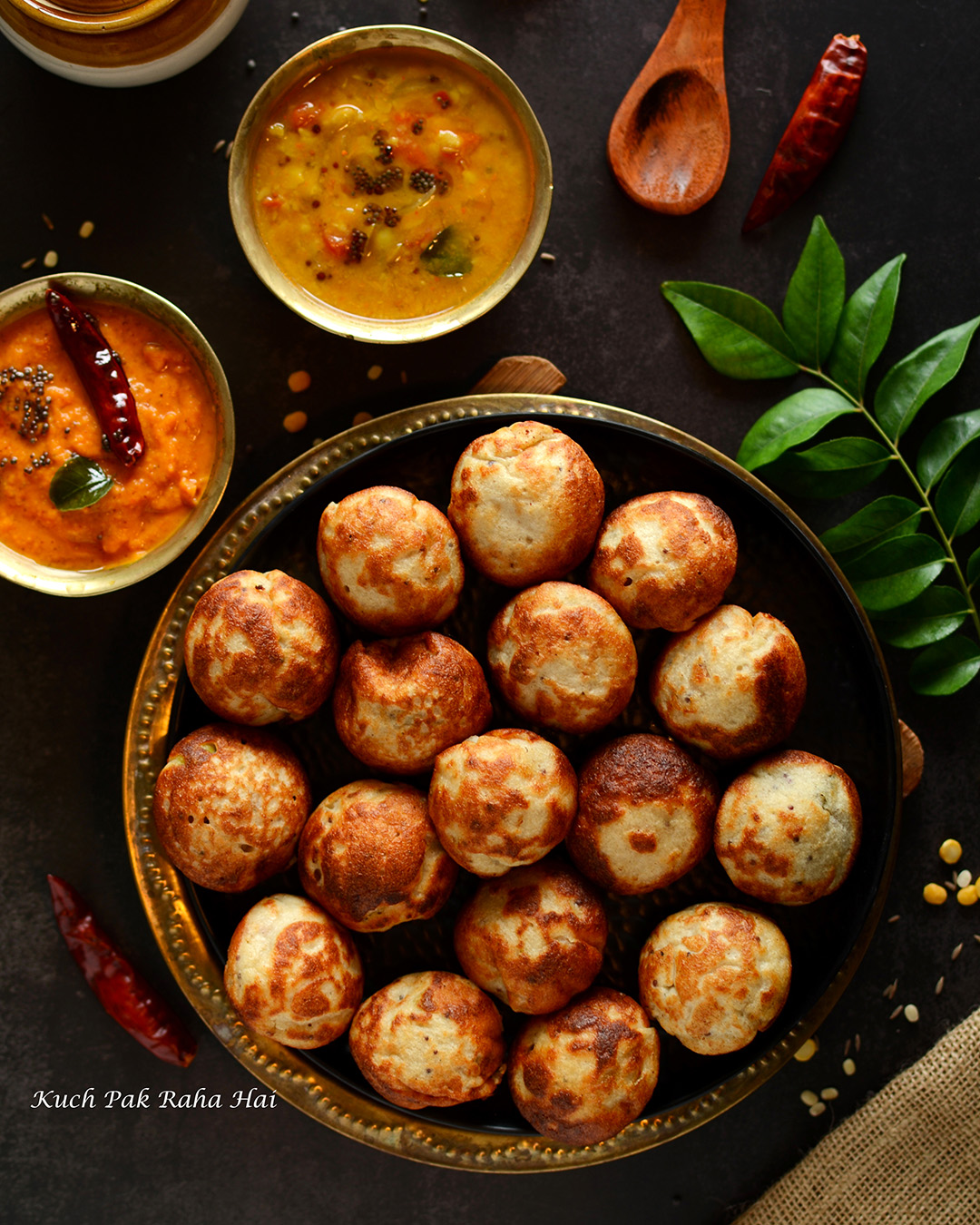 Quinoa lentil paniyaram served with sambhar and chutney.