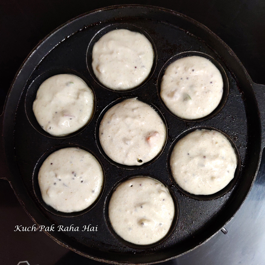 Pouring batter in appe pan.