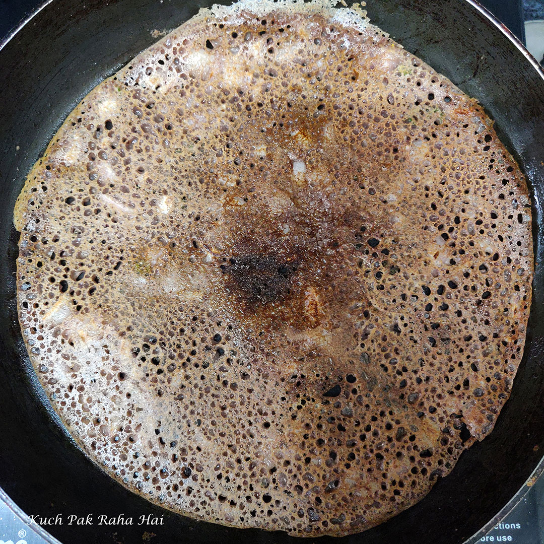 Flipping ragi dosa.