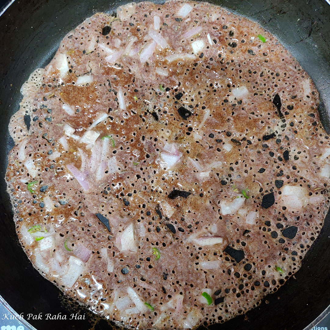 Cooking ragi dosa.