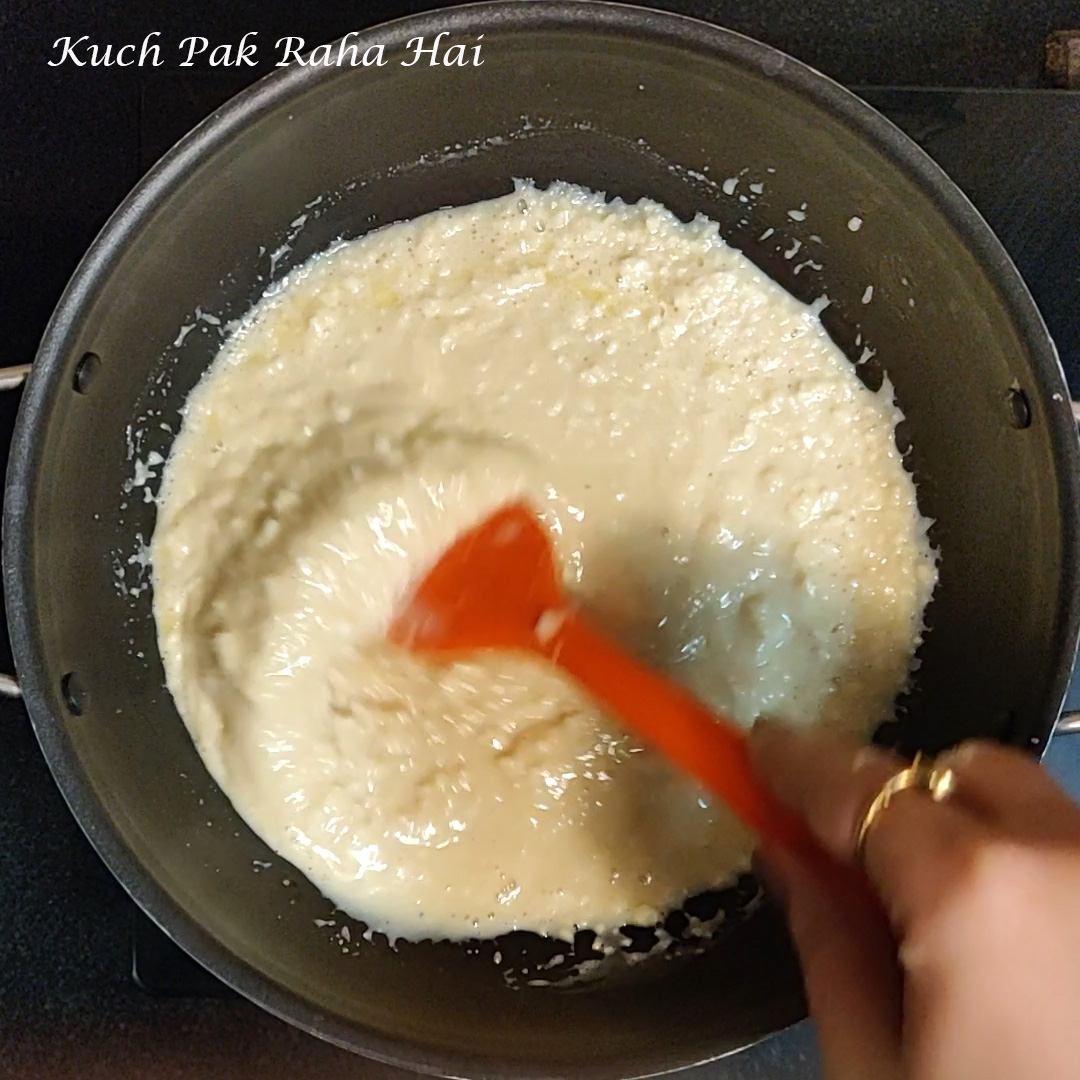Adding condensed milk to crumbled paneer.