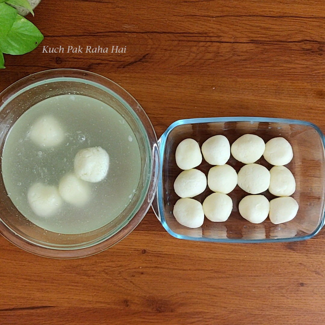 Squeezing rasgulla to remove excess syrup.
