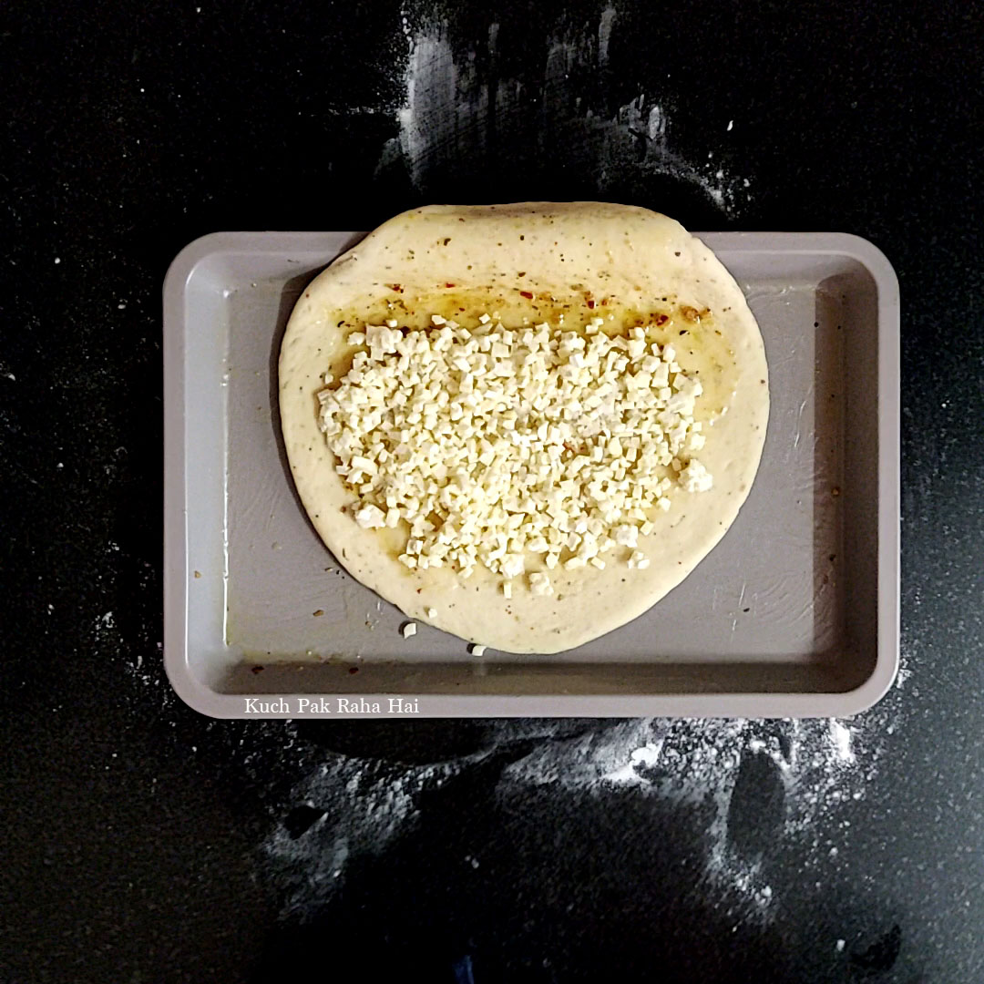 Adding cheese stuffing to garlic bread.