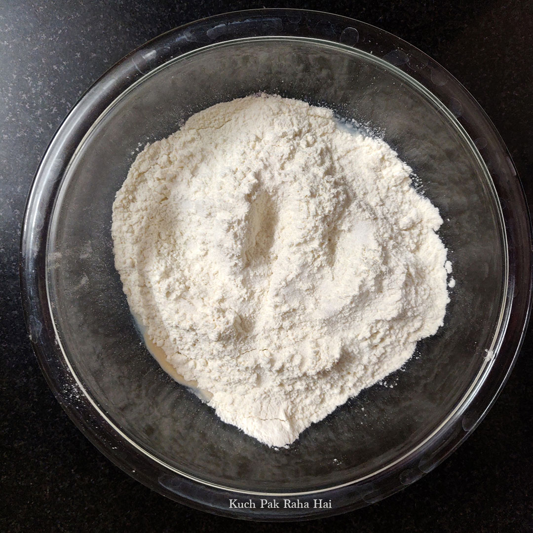 Adding flour to water yeast mixture.