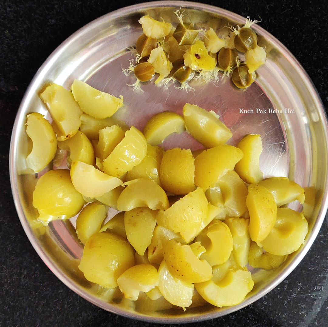 Deseeding amla or gooseberries.
