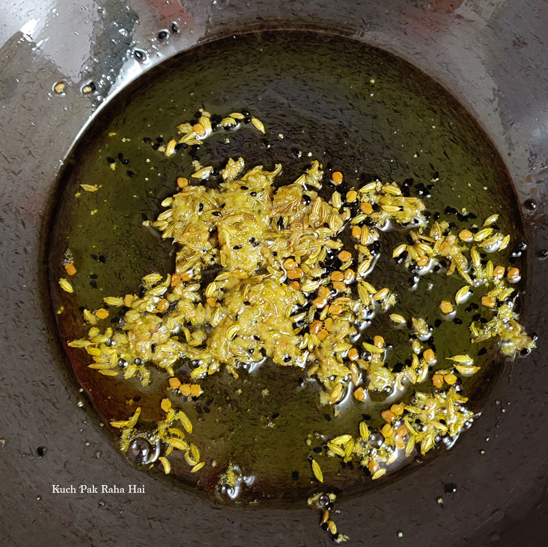 Sautéing spices in oil.