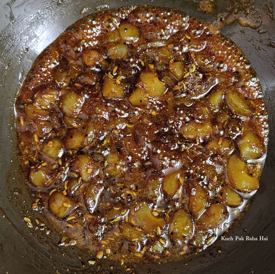 Cooking amla ki launji till it thickens up.