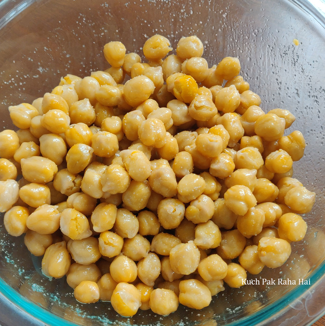 Adding salt & oil to chickpeas before air frying.