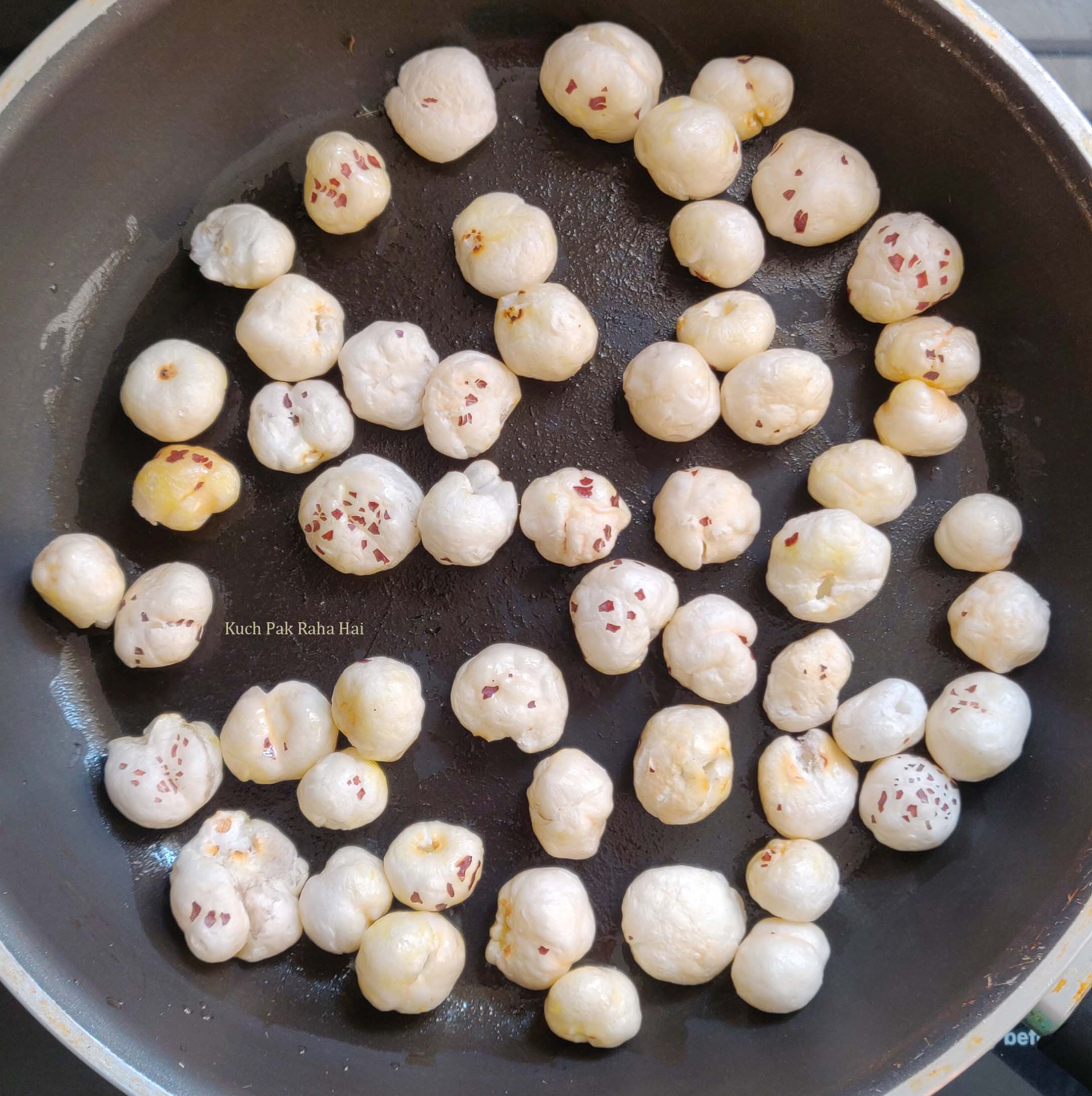 Roasting makhana for kulfi.