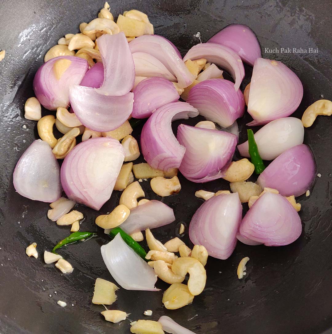 Sautéing onion, cashews & green chillies.