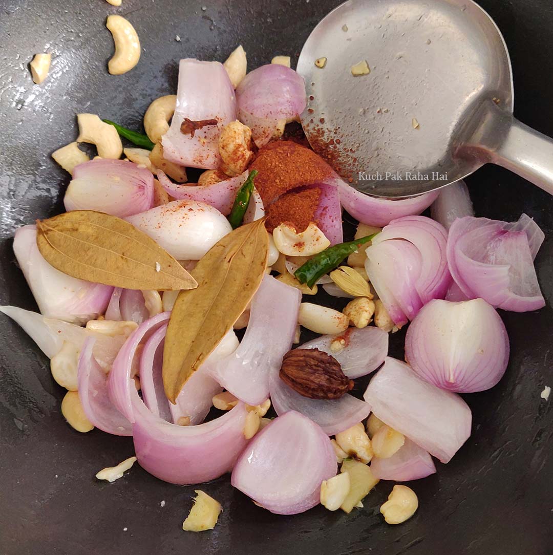 Cooking whole spices with onions.