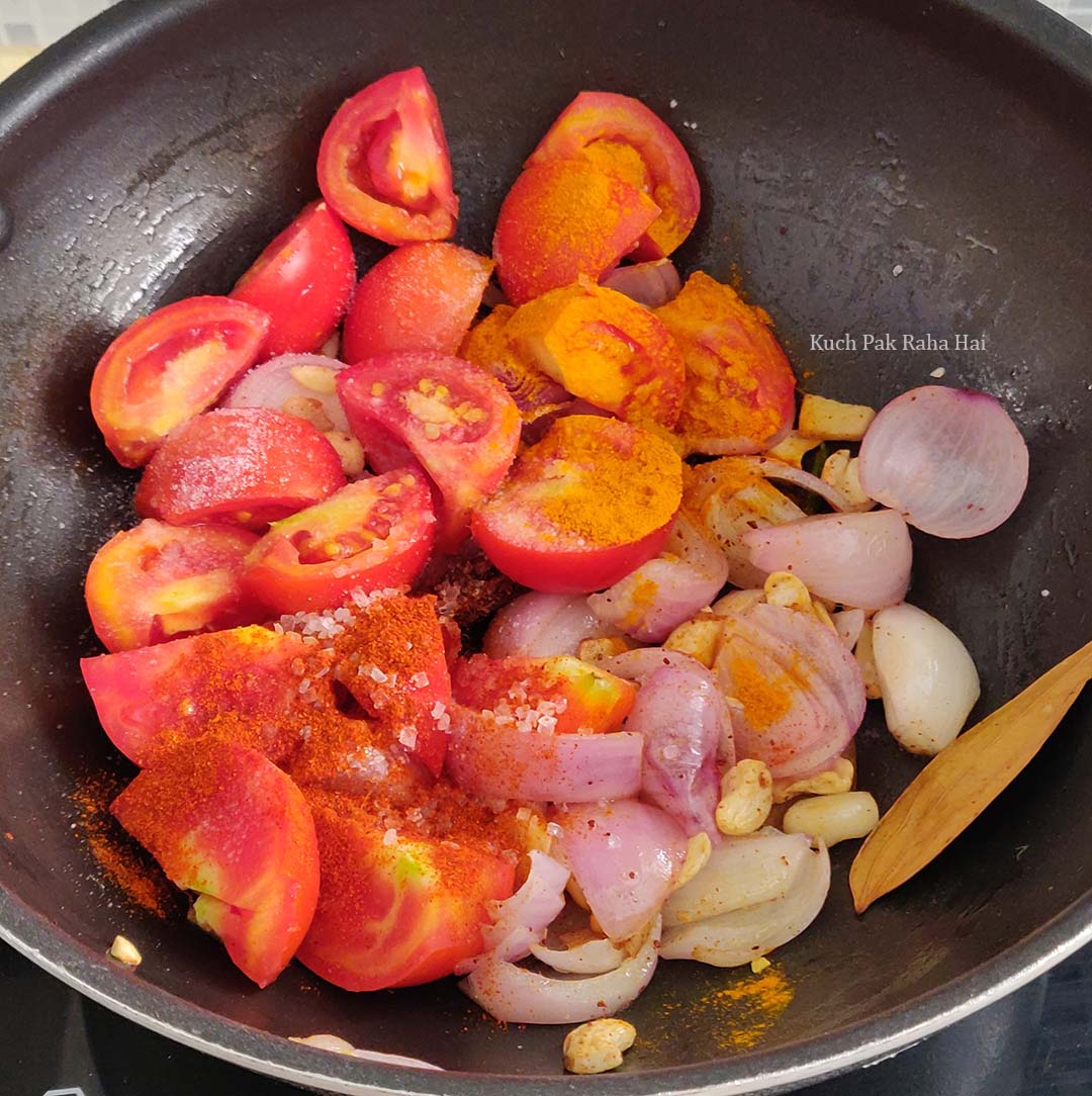 Cooking tomatoes and powdered spices.