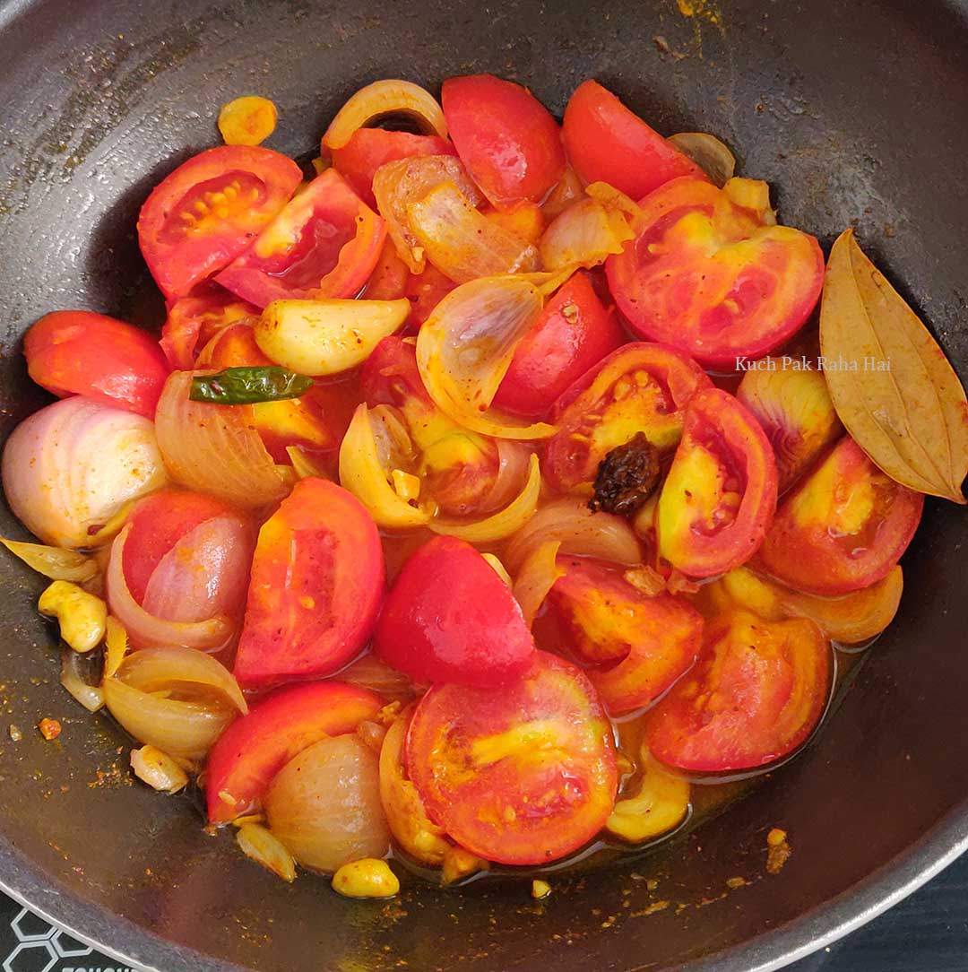 Simmering onion and tomatoes for shahi paneer gravy.