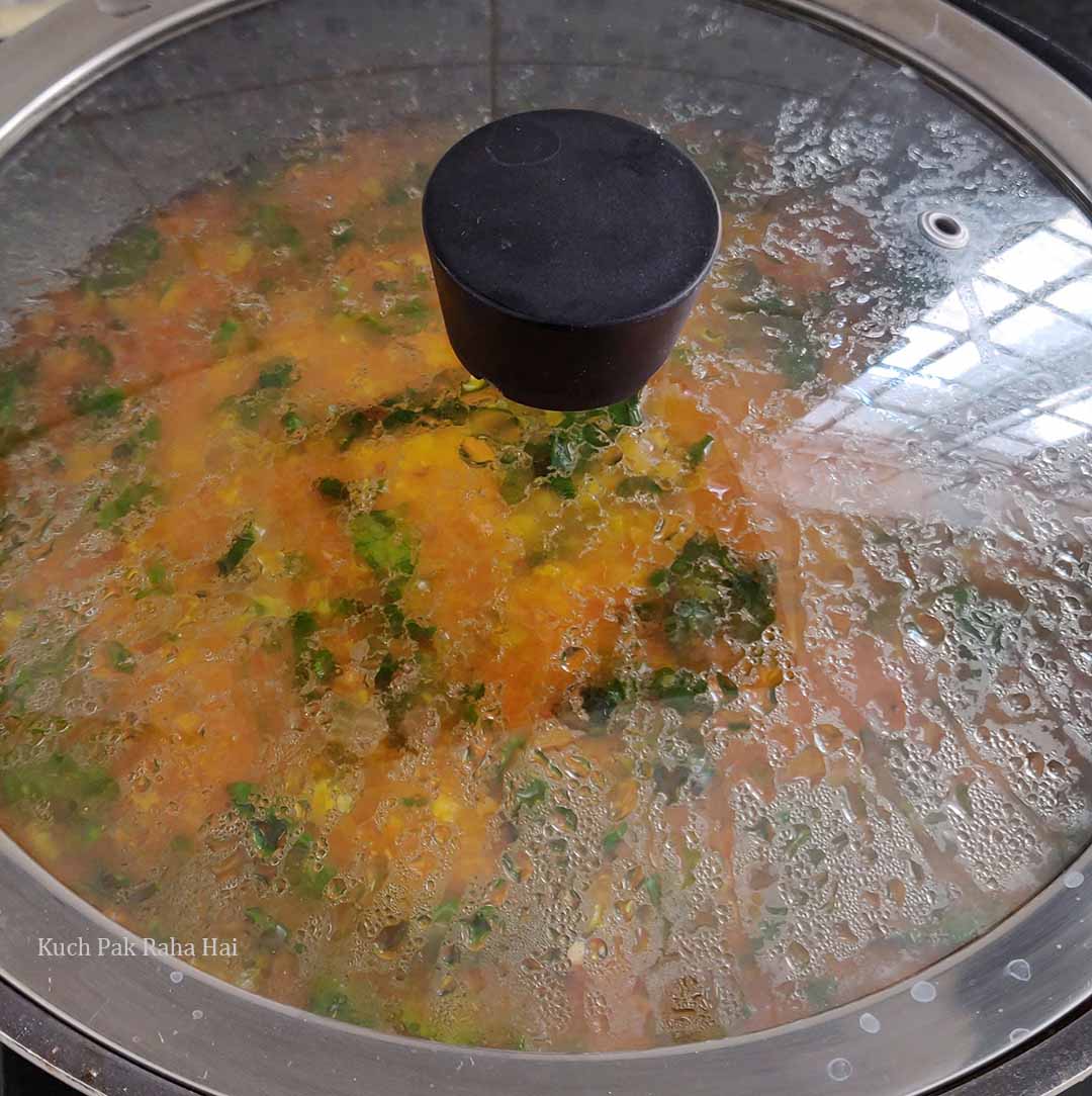 Simmering dal palak in pot.