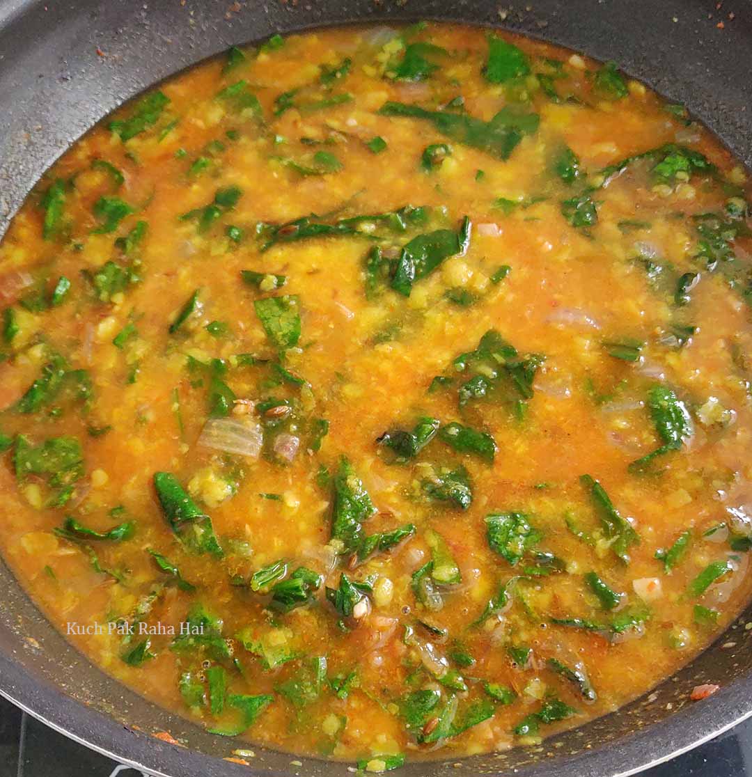 Spinach and lentils curry in a pot.