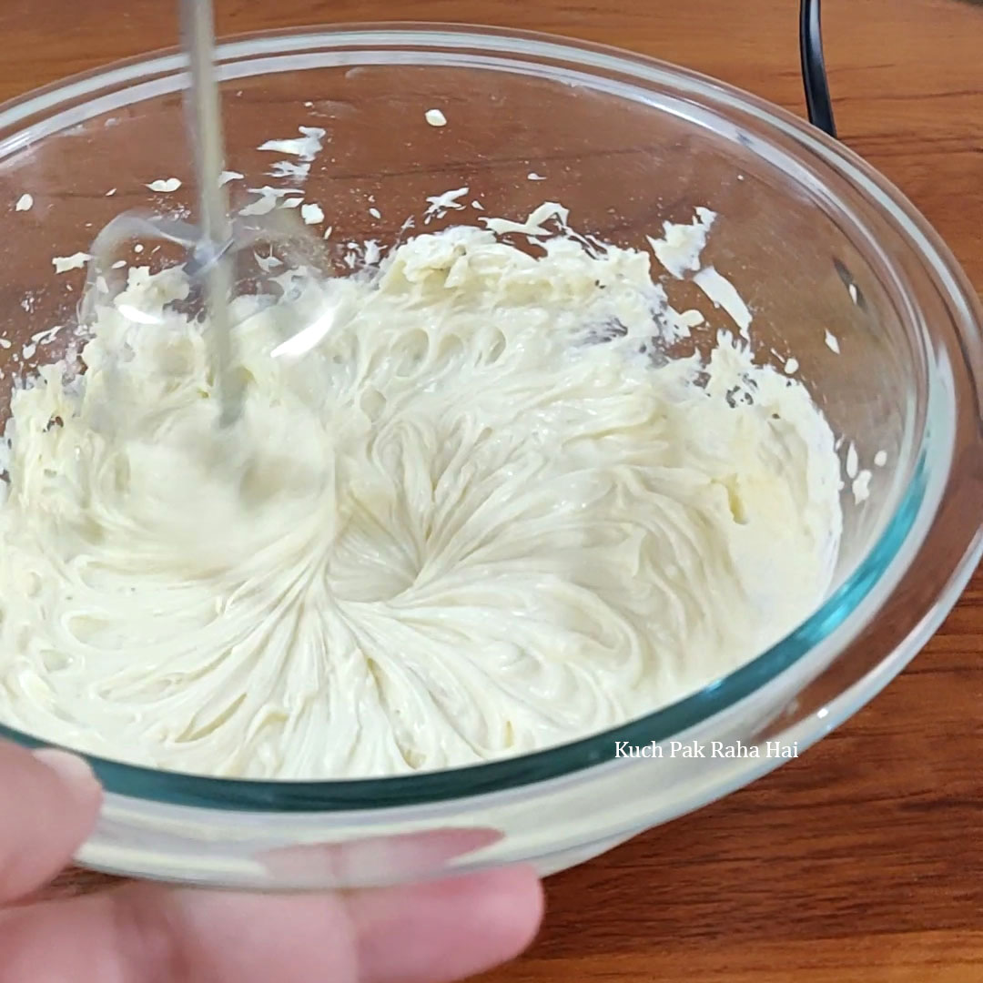 Whisking cream cheese & sugar.