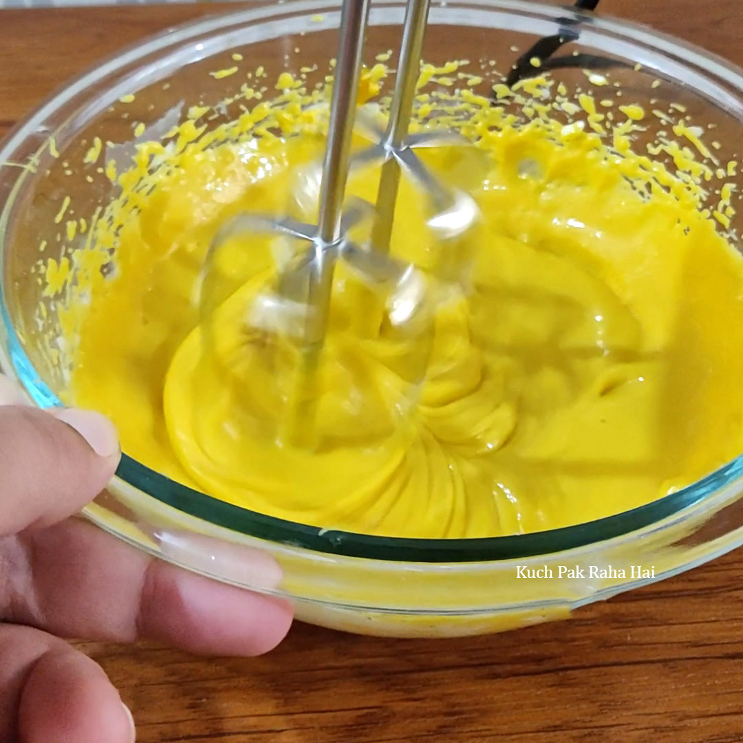 Preparing mango cream cheese filling for cheesecake.