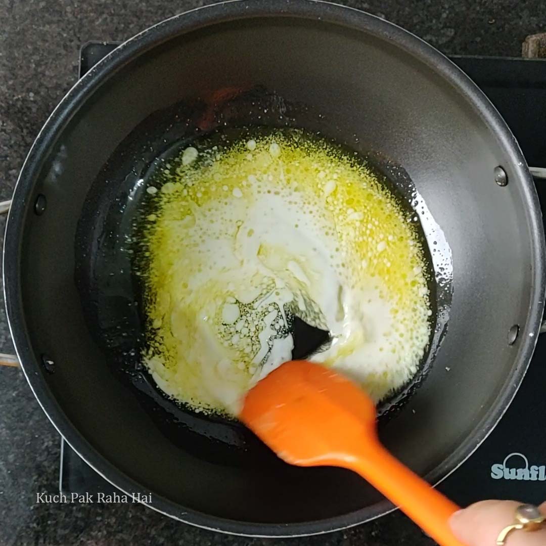 Cooking ghee and milk in a deep pan.