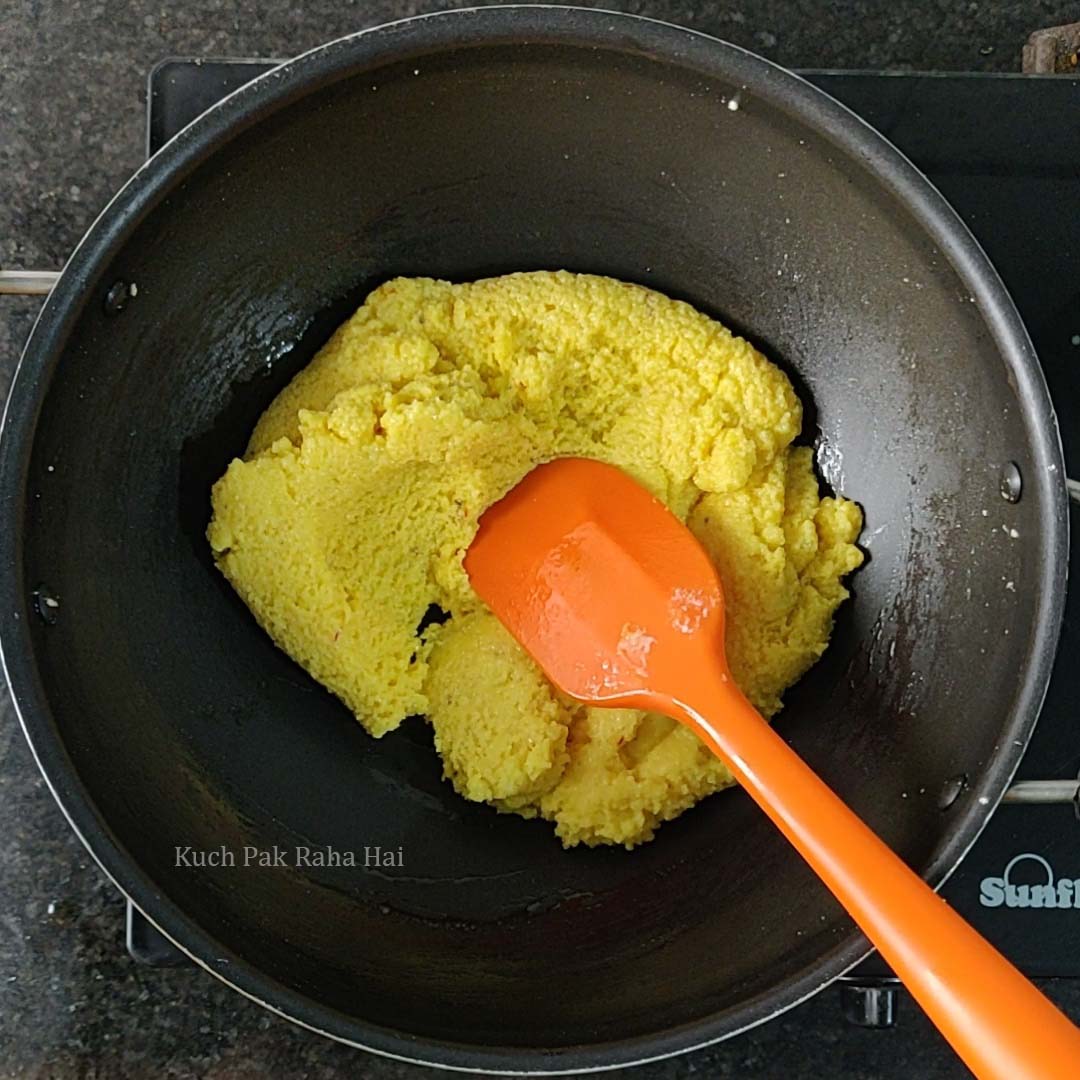 Barfi mixture starts to leave pan.