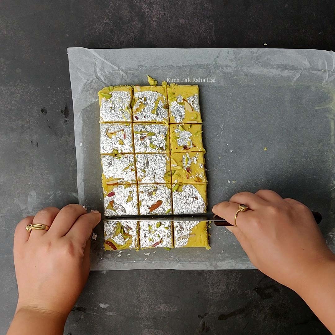 Cutting burfi into squares.