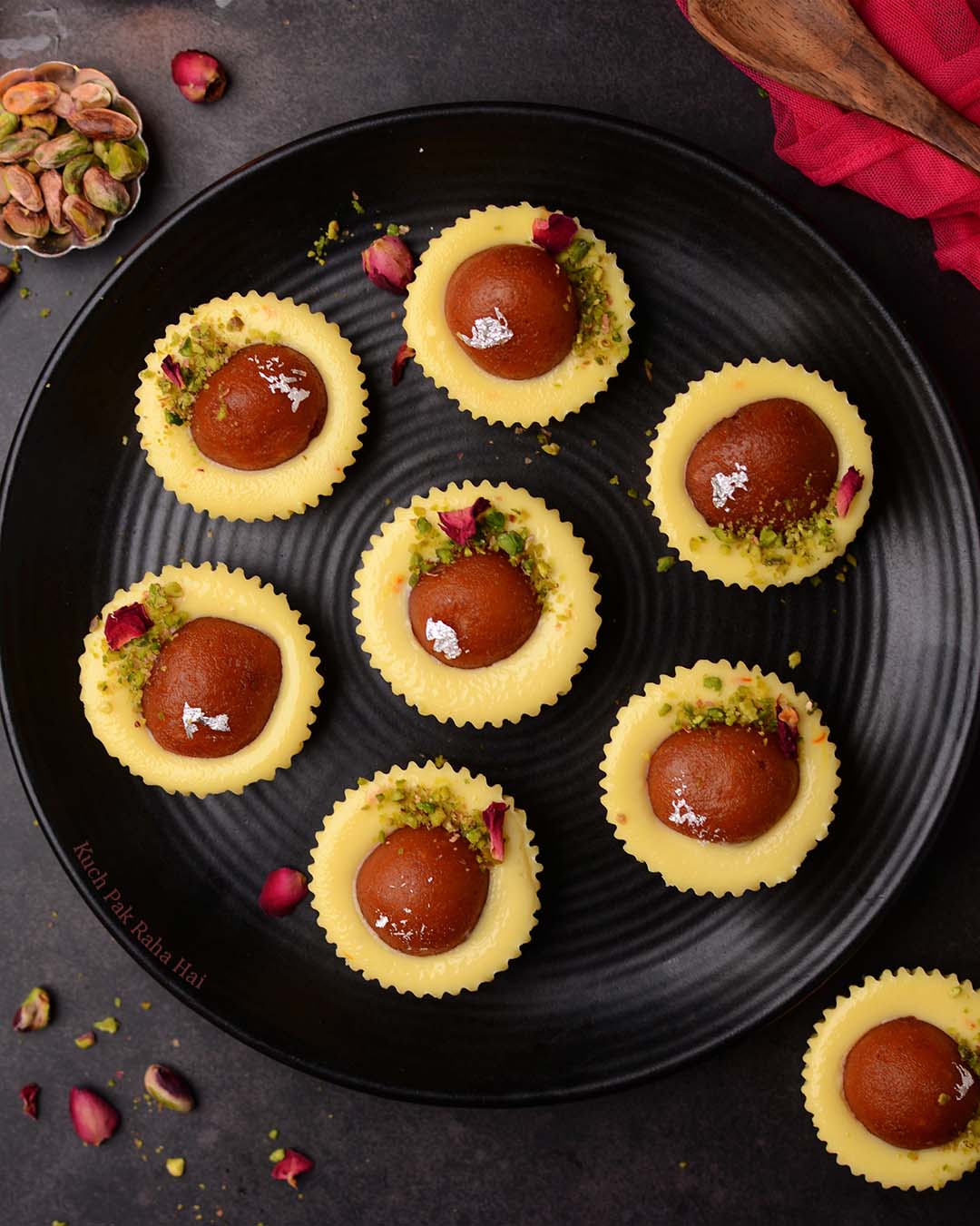 Gulab Jamun Cheesecake served on black plate.