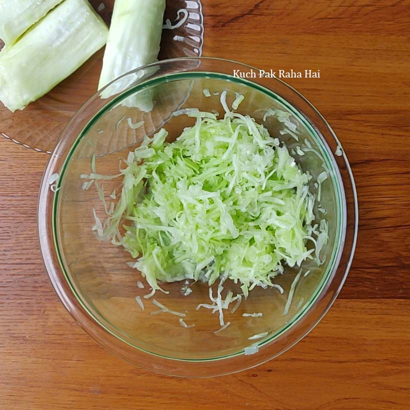 Peeling and grating the lauki.