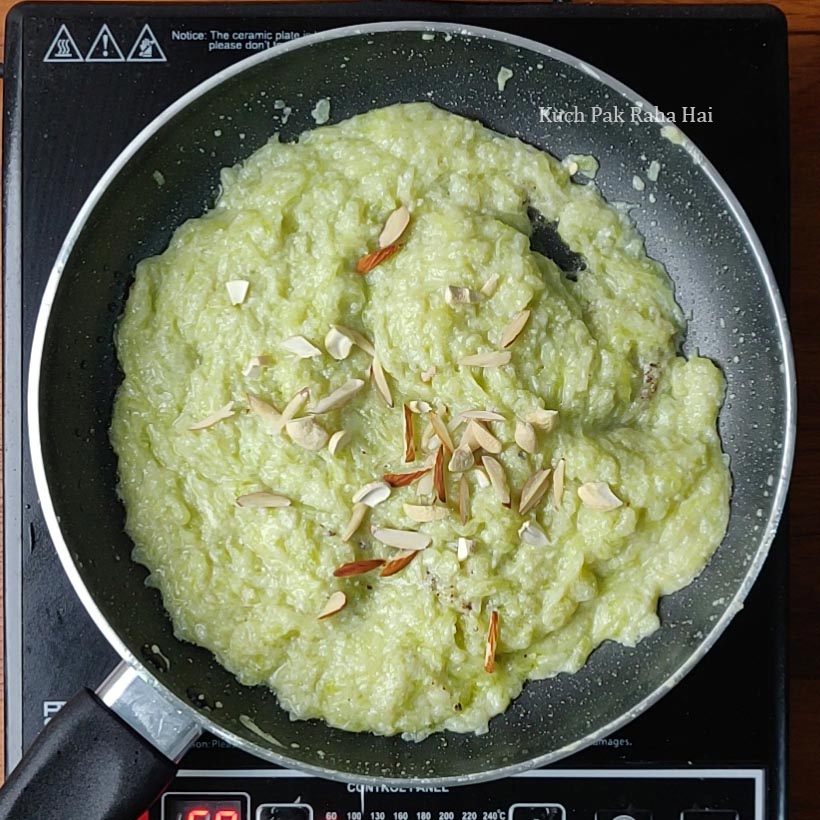 Adding nuts and cardamom to halwa.