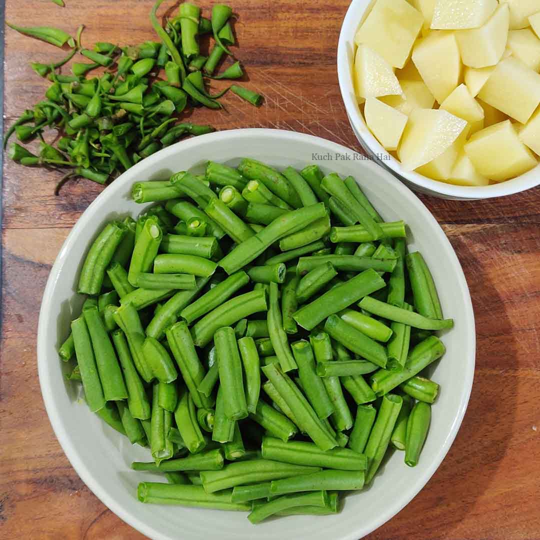 Chopping green beans or french beans & potatoes.