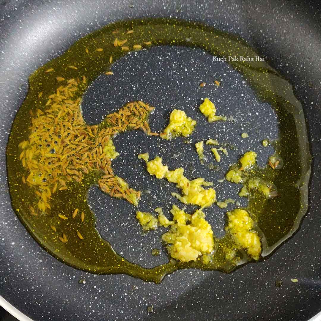 Sautéing cumin & ginger paste in oil.