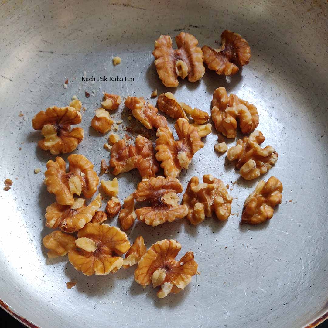 Toasting walnuts in pan.