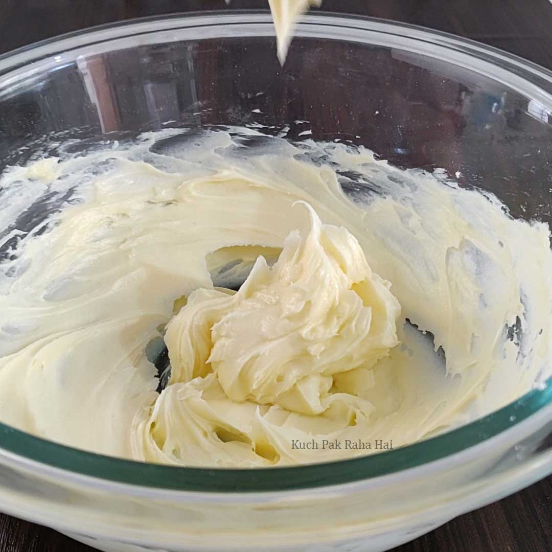 Whisking butter & sugar in a bowl.
