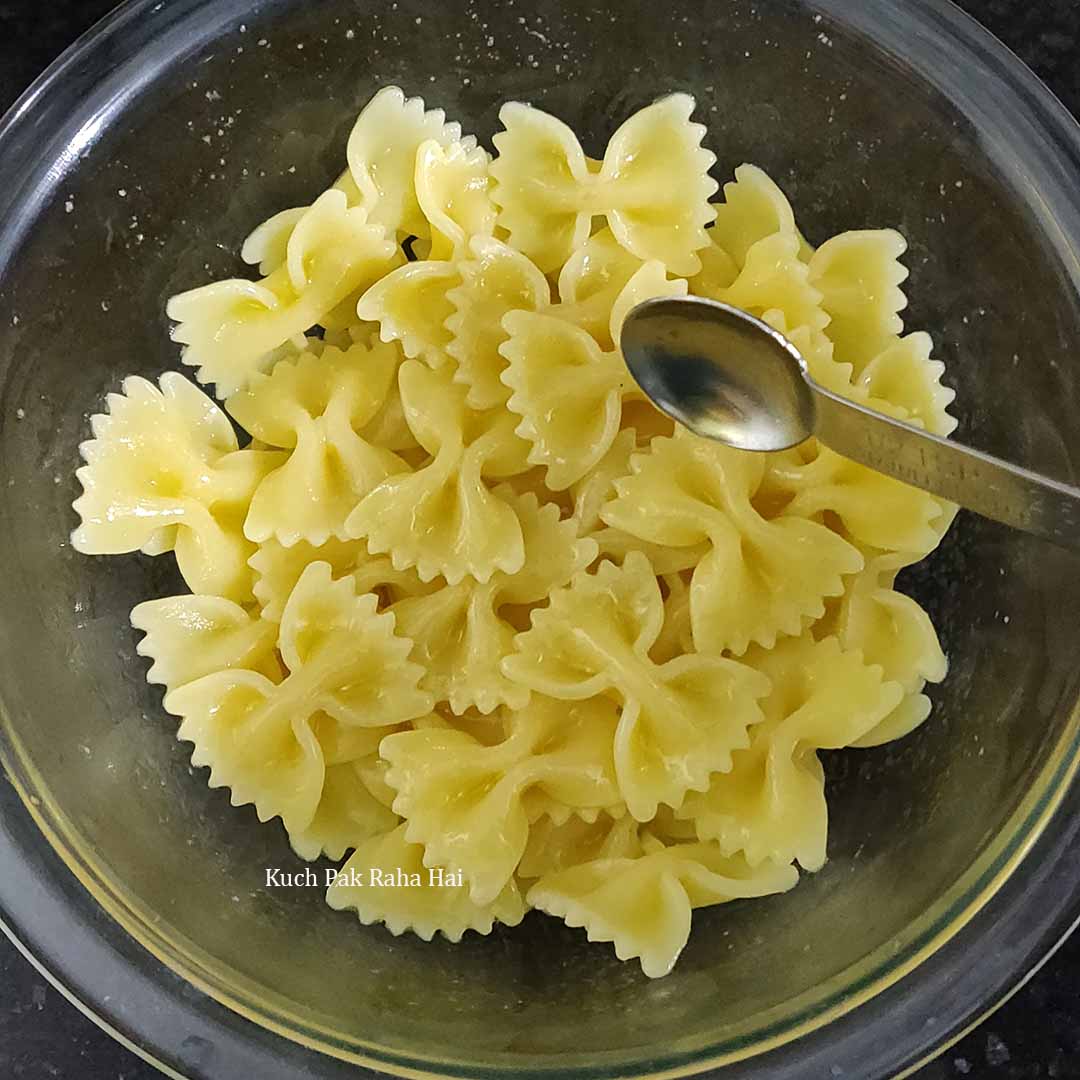 Adding salt olive oil to boiled pasta.