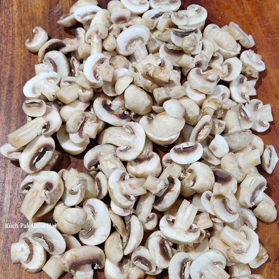 Slicing mushrooms on chopping board.