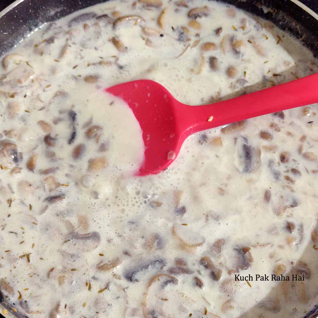 Adding milk to the cooked mushrooms.