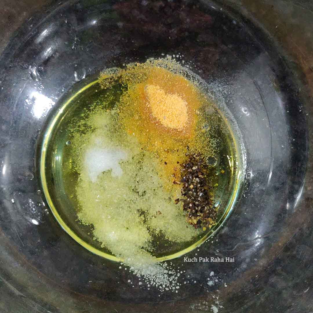 Mixing olive oil & seasoning.