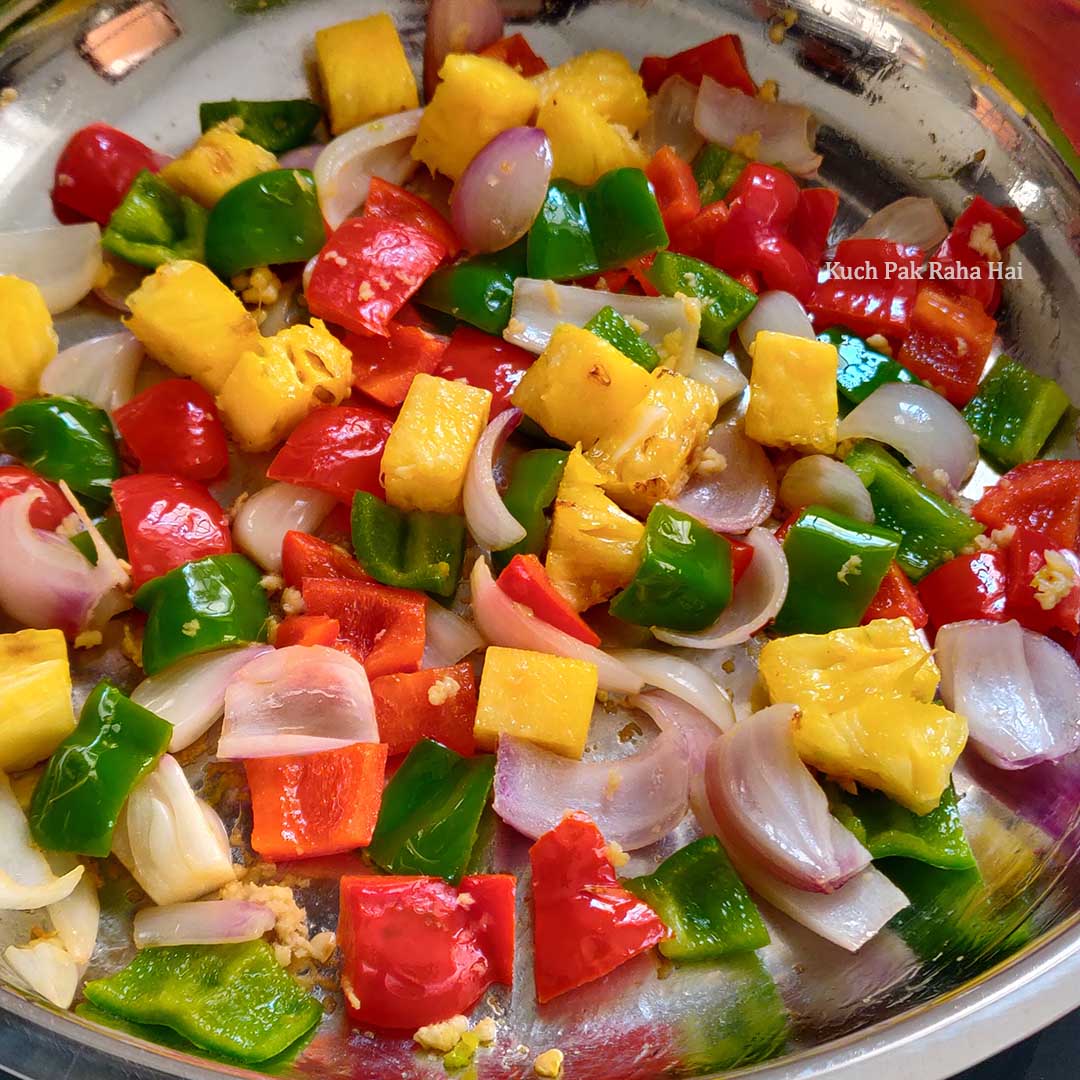 Sauteeing onions, bell peppers & pineapples.