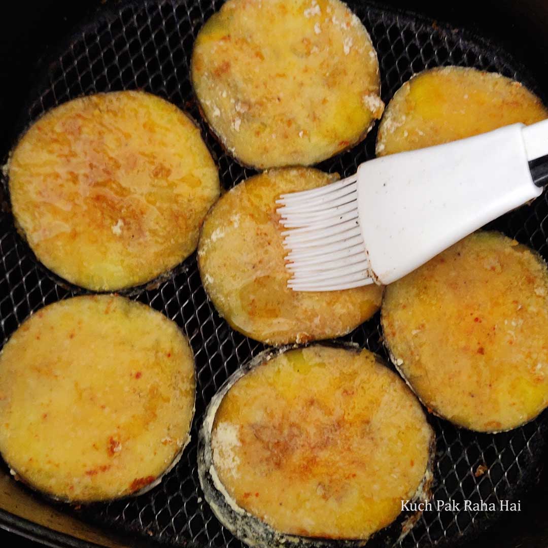 Brushing oil on eggplant.