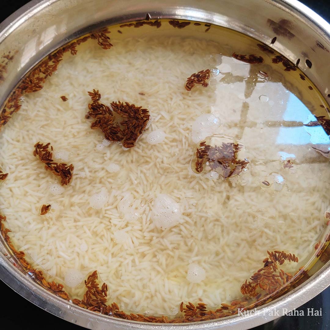 Adding basmati rice to boiling water.