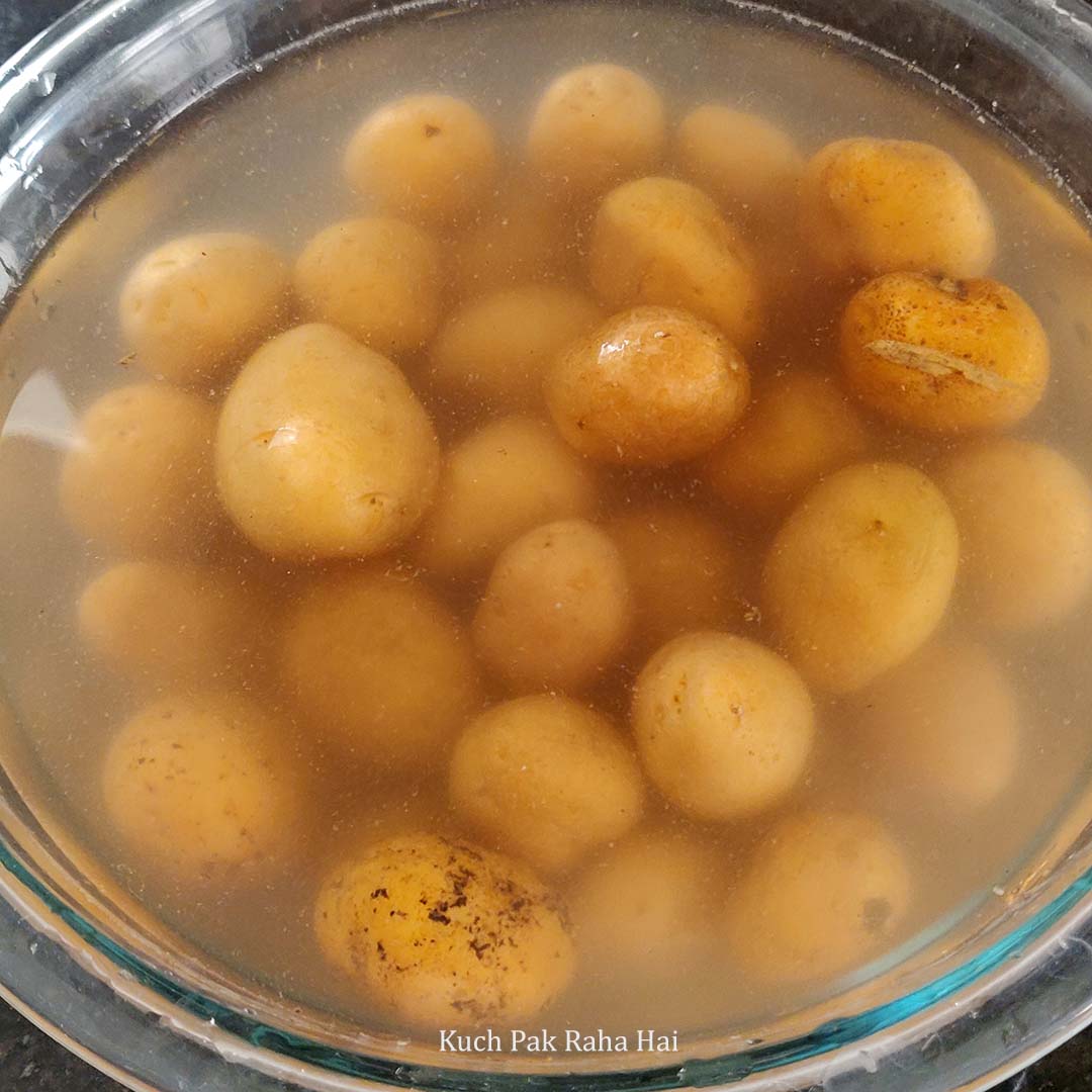 Washing scrubbing baby potatoes.