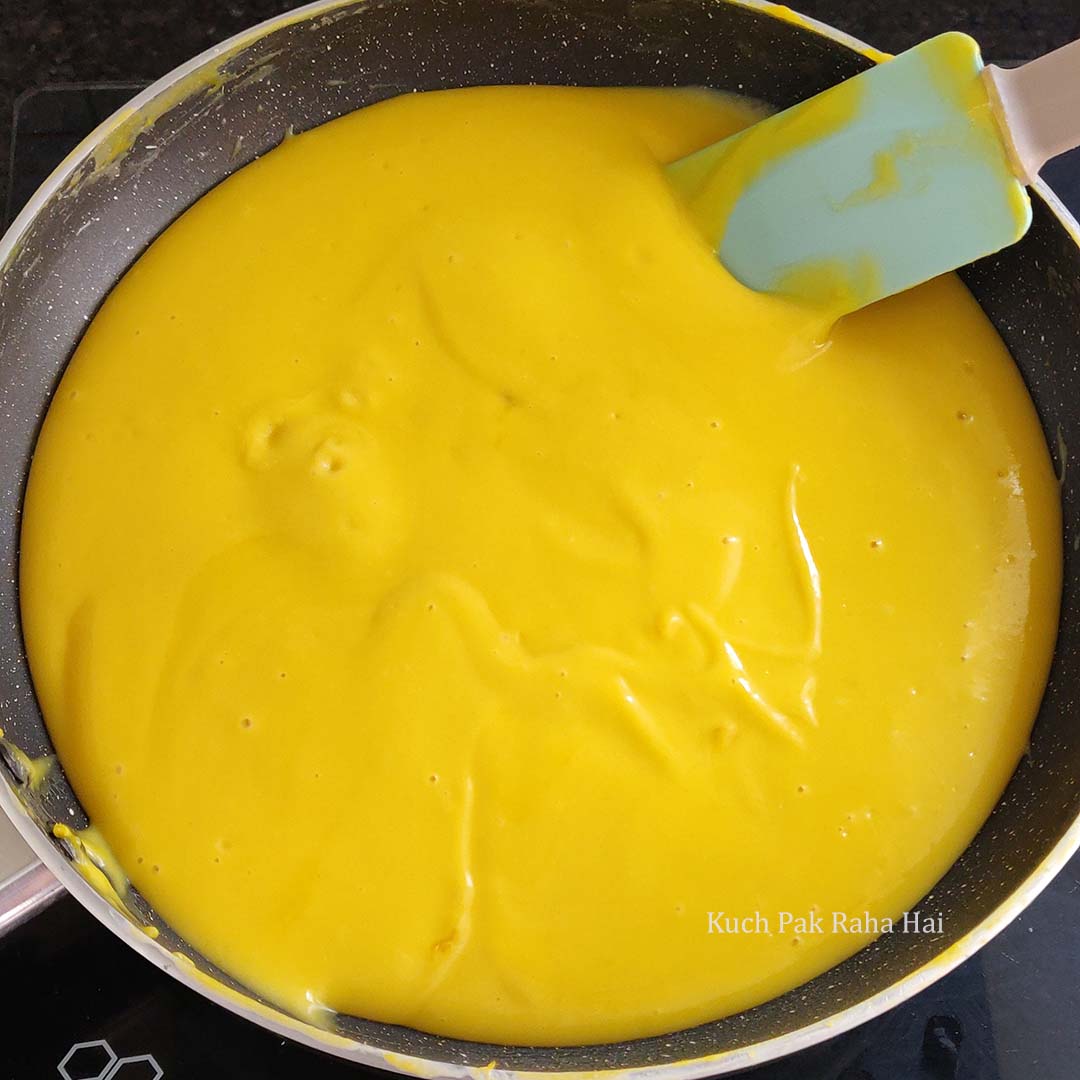 Adding mango puree to panna cotta mixture