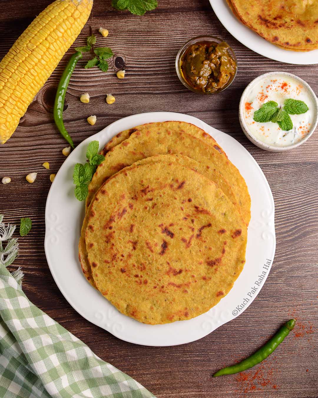 Sweet corn paratha with pickle & raita.