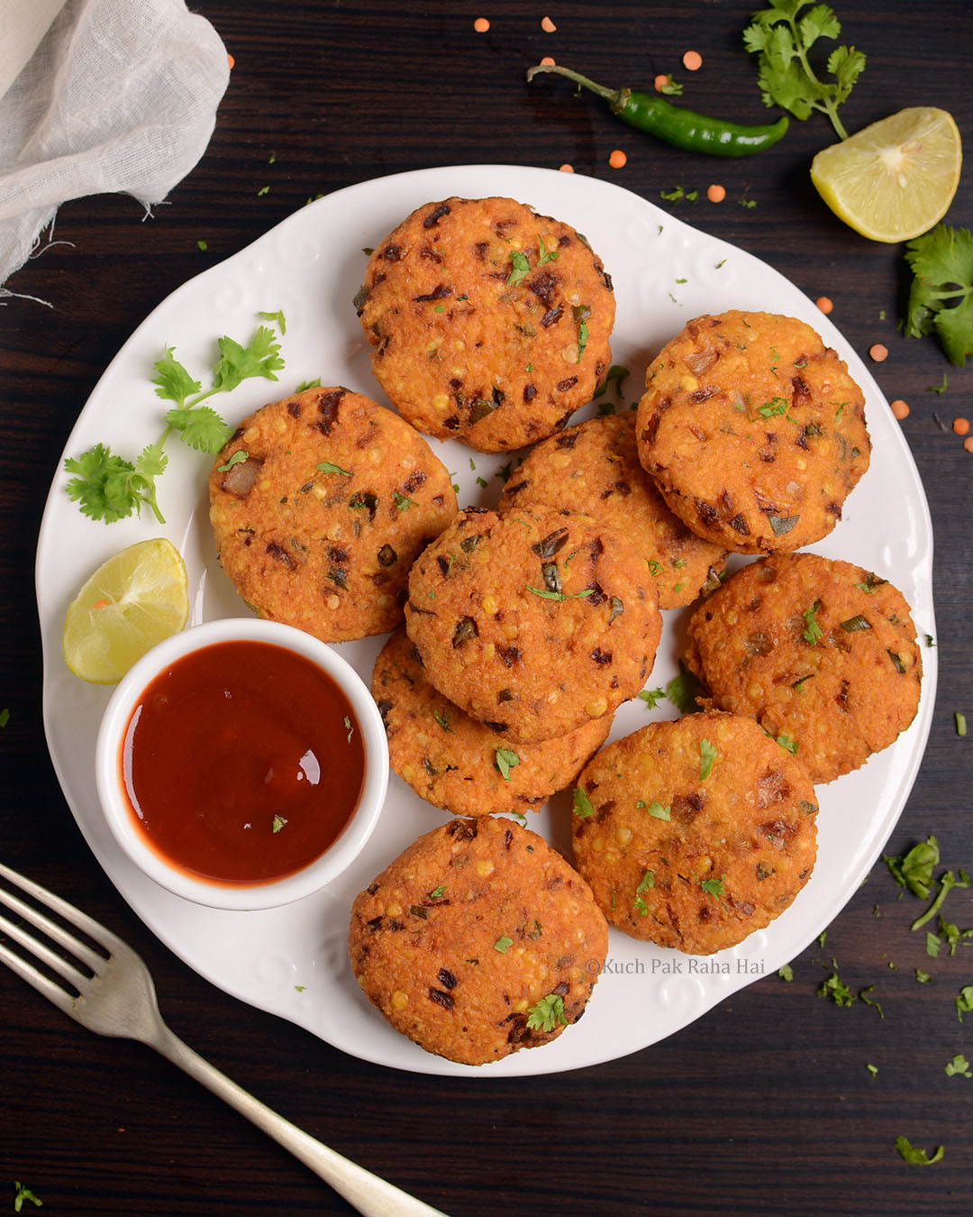 Masoor Dal Vada served with ketchup.