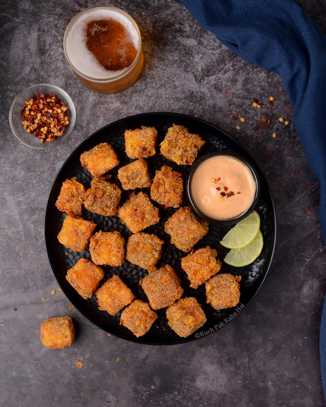 Paneer Nuggets or Paneer Popcorn served on black plate with chilli mayo.