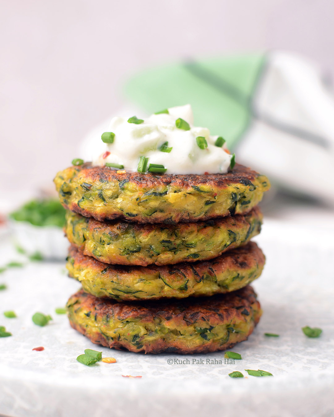 Zucchini fritters served with tzatziki or yogurt dip.