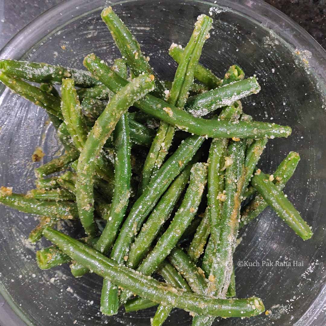 Adding spices to green beans.